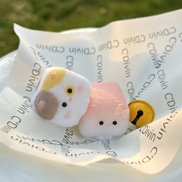 Two Cube Cat slow-rise silicone squishies on paper wrap